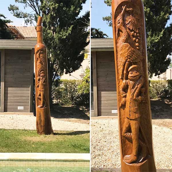 Totem au bord de la piscine par le sculpteur sur bois Pascal Cousin